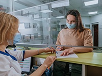 Patient in Belchertown filling out paperwork for dental emergencies