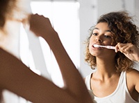 Patient in Belchertown brushing after dental emergencies