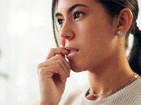 Closeup of woman biting her nails