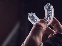 Patient holding clear mouthguard