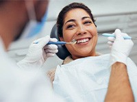 Woman smiling at dentist during checkup