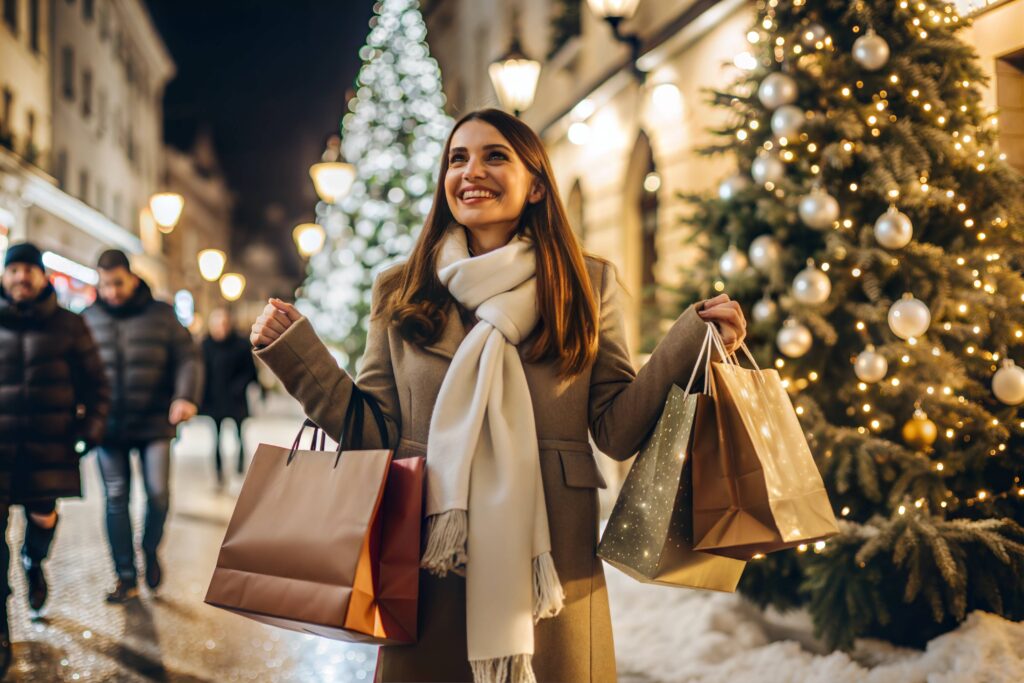 Woman smiling while holiday shopping at outdoor mall